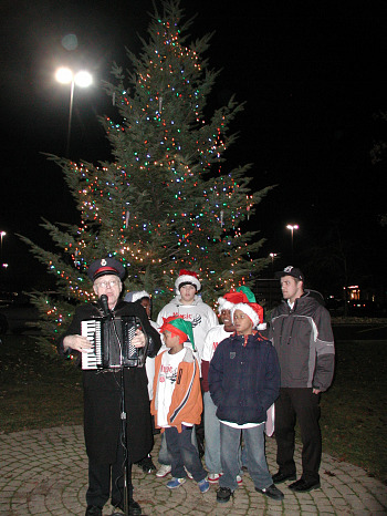 Briarwood Tree Lighting Lit tree with Choir.JPG