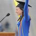 University of Michigan senior Julia Ruth Brennan, who gave a commencement speech, cheers after taking off her robe, revealing a maize and blue spandex suit. Angela J. Cesere | AnnArbor.com
