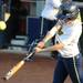Michigan junior short stop Amy Knapp hits the ball. Angela J. Cesere | AnnArbor.com
