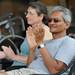 Ann Arbor residents Bipin Patel, right, and Sophie Grillet clap after a song performed by Oren Levin during the AnnArbor.com Summer Concert Series on the patio on Friday afternoon. Angela J. Cesere | AnnArbor.com