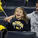 Toledo resident Bill LaGrange, right, watches his 4-year-old daughter Carli cheer during the basketball game. Angela J. Cesere | AnnArbor.com
