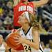 Ohio State guard Samantha Prahalis, top, jumps to block a shot by Michigan guard Jenny Ryan. Angela J. Cesere | AnnArbor.com