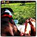 A boxer and its owner watch an afternoon soccer game on Saturday. (kirkir85)