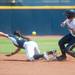 Wolverines senior Ashley Lane slides in to second base as California's Cheyenne Cordes missing the ball during the second inning of their game, Saturday May 18.
Courtney Sacco I AnnArbor.com     