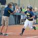 Wolverines junior Caitlin Blanchard  high fives head coach Carol Hutchins after hitting a home run in the sixth inning of the NCAA regional title game against California, Sunday May 19.
Courtney Sacco I AnnArbor.com 