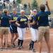 Wolverines head coach Carol Hutchins high fives her players after winning the NCAA regional title game against California, Sunday May 19.
Courtney Sacco I AnnArbor.com  