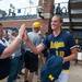 Wolverines pitcher Sara Driesenga high fives fans outside the dugout after winning the NCAA regional title game against California, Sunday May 19.
Courtney Sacco I AnnArbor.com  