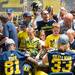Freshmen wide receiver Csont'e York and running back Wyatt Shallman sign autograph for fans during youth day at Michigan Stadium, Sunday, August, 11.
Courtney Sacco I AnnArbor.com 