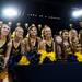 Michigan cheerleaders pose for a picture behind the NCAA South Regional trophy at Crisler Arena on Monday, April 8. Daniel Brenner I AnnArbor.com