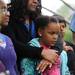 Dicken Elementary School parent Ciceley Lawson stands with her daughters, Kennedy, age 8, bottom, and Kayla, age 10, left, during the memorial bench dedication in memory of Mariel Almendras.  Angela J. Cesere | AnnArbor.com