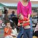 Ann Arbor resident Marie Doucet dances with her 2-year-old son, Ruben, during Nashbash at the Ann Arbor Farmer's Market on Thursday evening.  Angela J. Cesere | AnnArbor.com