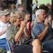 Whitmore Lake residents Linda Gamnes, center left, and her husband Steve Chaikin, center right, clap for musician Kathy Hussey. Angela J. Cesere | AnnArbor.com