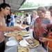 John Bellfi, left, of Silvio's Organic Pizza serves up a slice of pizza to Ann Arbor residents Ryann Patten, age 13, far right, and her grandmother Pat Ballard. Angela J. Cesere | AnnArbor.com