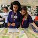 Dicken Elementary School 4th graders Sarah Akaaboune, left, and Morraina Tuzinsky, solve geographical questions with maps during the map during portion of the Washtenaw Elementary Science Olympiad at Pioneer High School Saturday afternoon. Angela J. Cesere 