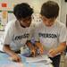 Emerson Elementary School 4th graders Shil Deenadayalu, left, and Kaan Oral use maps to answer questions during the map reading portion of the Washtenaw Elementary Science Olympiad. Angela J. Cesere 