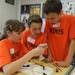  From left: Wines Elementary 4th graders Sara Soluk, Conleth Stead, and Benjamin Nacht wire a circuit. Angela J. Cesere 