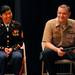 Former Ann Arbor resident and current Navy Petty Officer 1st Class, James Penney, right, and Marine Corps. Sgt. Bao Lee, left, answer questions about the military from 7th graders during an assembly to commemorate Memorial Day at Scarlett Middle School on Friday morning. As part of the assembly, Penney and Lee were given plaques from the school to thank them for their continued military service. Angela J. Cesere | AnnArbor.com