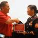 Scarlett Middle School 7th and 8th grade English teacher Salvador Barrientes, left, gives Marine Corps. Sgt. Bao Lee a plaque to commemorate her continued Military Service during an assembly to commemorate Memorial Day at Scarlett Middle School on Friday morning. As part of the assembly, Lee and Navy Petty Officer 1st Class, James Penney, answered questions about the military and their service. Angela J. Cesere | AnnArbor.com