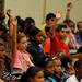 Scarlett Middle School 6th graders raise their hands to ask Navy Petty Officer 1st Class James Penney and Marine Corps. Sgt. Bao Lee questions about the military during an assembly commemorating Memorial Day. Angela J. Cesere | AnnArbor.com