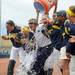 A bucket of water is thrown on Michigan head softball coach Carol Hutchins after Michigan was given the Big Ten conference title after beating Purdue Saturday afternoon. Angela J. Cesere | AnnArbor.com