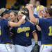 Michigan teammates celebrate after clinching the Big Ten title, beating Purdue 8-5 in their second game of a three game series against them on Saturday. Angela J. Cesere | AnnArbor.com