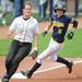 Purdue senior Molly Garst, left, watches the play as Michigan senior Bree Evans reaches third base. Angela J. Cesere | AnnArbor.com