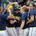 Teammates congratulate Michigan junior Amy Knapp after Knapp hit a home run against Purdue in the third game of the series on Saturday afternoon. Angela J. Cesere | AnnArbor.com