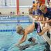 Liberty swim team coach Kyle Anderson, right, cheers on 6-year-old Sam Shemke as he dives in the pool after teammate Ben Mendez, age 6, touches the wall in heat 1 of the boys 8 and under 100 yard freestyle relay. Angela J. Cesere | AnnArbor.com 