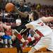 Milan's C.J. Turnage  jumps to make a basket against Temperance Bedford's Jackson Lamb during the secound half of the district final game at Temperance Bedford high school Friday Mar. 8th.
Courtney Sacco I AnnArbor.com  