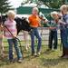 Jada VanRiper, age 6, Bria VanRiper, age 8, Nathan Christien, age 6 and Heidi Fuchs, age 7, wait for the start of the junior class of feeder calf judging to start at the Chelsea Community Fair Wednesday, August 21. 
Courtney Sacco I AnnArbor.com 