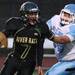 Huran's Alex Hassan escapes a sack from Skyline's Trevor Hill as Ann Arbor Huron takes on Ann Arbor Skyline Friday September 30, 2011 at Huron High School. Jeff Sainlar I AnnArbor.com 
